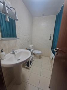 a bathroom with a sink and a toilet at Las Brisas in Granadilla de Abona +12 photos