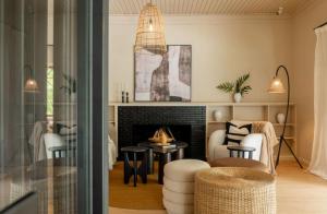 a living room with a fireplace and a table and chairs at Tulia Retreat Hotel and Spa in Arusha
