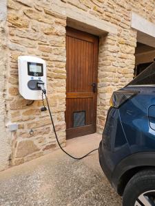 a car parked next to a building with a pay phone at Logis Hôtel-Restaurant Le Val d'Amby in Hières-sur-Amby +69 photos