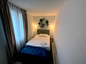 a small bedroom with a bed and a large window at San Carlo Luxury Apartments in Lugano
