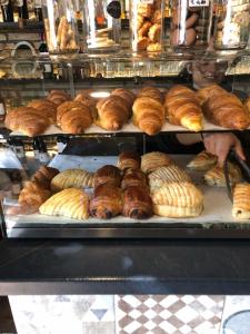 a display case with various types of bread and pastries at B&B Rome Vatican Residence in Rome