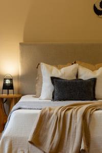a bedroom with a large bed with white sheets and pillows at Tulia Retreat Hotel and Spa in Arusha