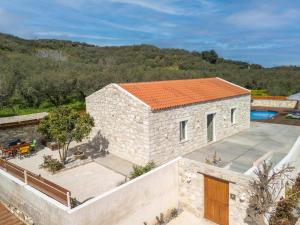 an aerial view of a stone house with an orange roof at Villa Lakioto in Dhémbla