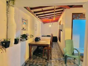 a dining room with a table and two chairs at Dinu Senu Dream Guest in Midigama