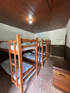a group of bunk beds in a room at Pousada & Camping Santa Clara in Santa Helena +26 photos