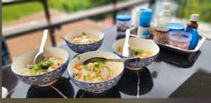 a table with four bowls of food on a table at น้ำหนาวโฮมสเตย์เขาค้อ2 in Campson