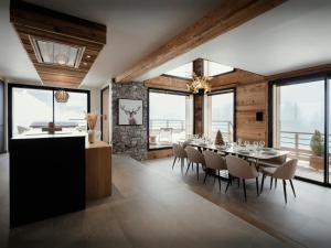 a dining room with a table and chairs and windows at Chalet 1786 - OVO Network in Notre-Dame-de-Bellecombe +26 photos