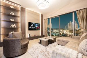 a living room with a couch and a large window at NEW YEARS Luxury Burj Khalifa and Fountain Views in Dubai