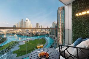 a balcony with a table and a view of a city at NEW YEARS Luxury Burj Khalifa and Fountain Views in Dubai