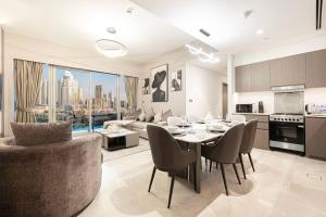 a kitchen and living room with a table and chairs at NEW YEARS Luxury Burj Khalifa and Fountain Views in Dubai