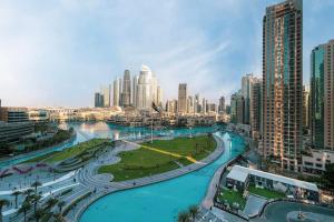 a view of a city with a river and buildings at NEW YEARS Luxury Burj Khalifa and Fountain Views in Dubai