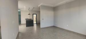 an empty room with white walls and a tile floor at Casa Europa Barretos in Barretos