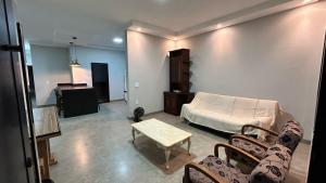 a living room with a bed and a table and chairs at Casa Europa Barretos in Barretos