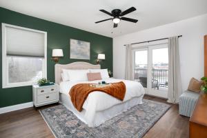 a bedroom with a bed and a ceiling fan at Rivertowne Escape Downtown Knoxville in Knoxville