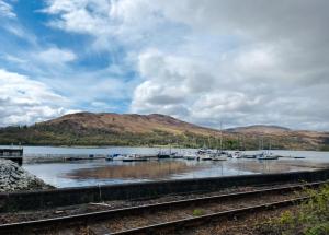 a view of a marina with boats in the water at Marina Apartments 1 in Corpach