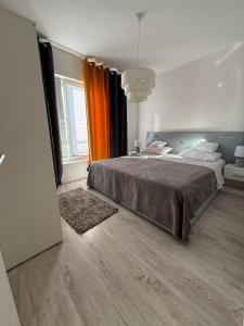 a bedroom with a large bed and a large window at Villa Kati in Bibinje