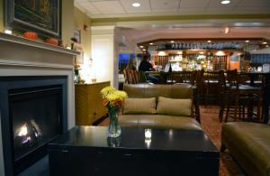 a living room with a fireplace and a couch at Deerfield Inn in Deerfield +32 photos