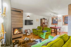 a living room with a green couch and a fireplace at Maison Villarisson Chalet di Charme La Salle a due passi dal Monte Bianco in Remondey