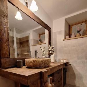 a bathroom with a wooden sink and a mirror at Maison Villarisson Chalet di Charme La Salle a due passi dal Monte Bianco in Remondey