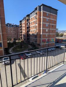 a train on a track in a city with buildings at The Yellow Brick Apartment in Tbilisi City