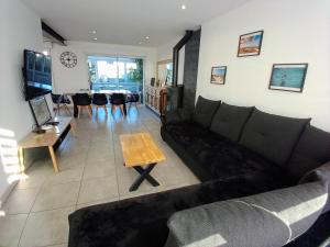 a living room with a couch and a table at Villa Ptit Rene in Dunkerque
