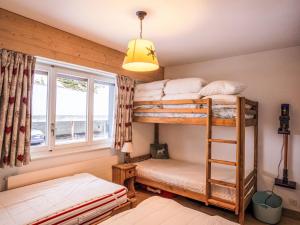 two bunk beds in a room with a window at Apartment Le Hameau-21 by Interhome in Les Collons