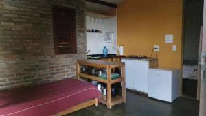 a kitchen with a counter and a table in a room at Solar de Bonito - Casa Romã in Bonito +21 photos