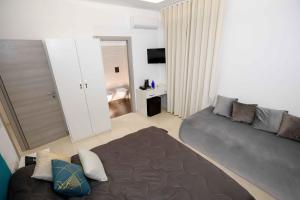 a living room with a couch and a bed at Relais San Giorgio in Pignataro Maggiore