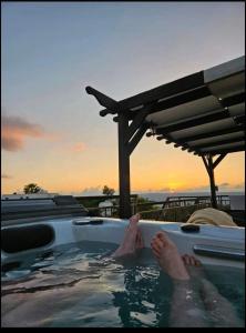 a person in a jacuzzi in a swimming pool at HideAway Lasa in Lasa