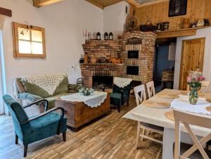 a living room with a table and a fireplace at Piecówka in Kaczkowo
