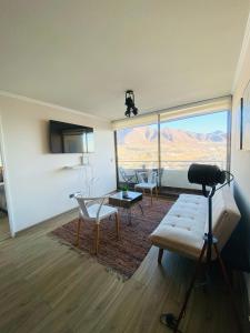 a living room with a view of a mountain at Maravilloso Departamento- Sector Sur-1Hab-1 Baño in Antofagasta
