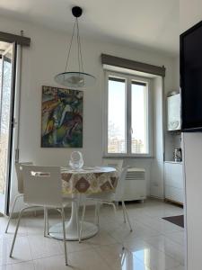 a kitchen and dining room with a table and chairs at La Riva Sinistra in Rome