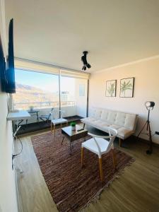 a living room with a couch and a table at Maravilloso Departamento- Sector Sur-1Hab-1 Baño in Antofagasta