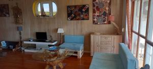 a living room with a table and a chair and a desk at Blue Lagoon Apartment Platinum in Lovište