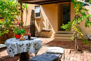 a table and a chair in a patio with a table at Old Roastery Cottage in Bloemfontein