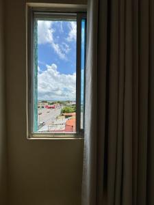 a window with a view of a city street at Comodoro Hotel e Churrascaria in Floriano