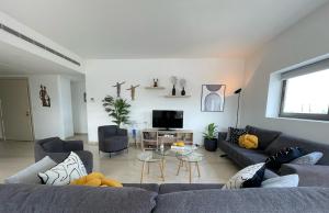 a living room with two couches and a tv at 2 Bedroom Apartment AYA tower Mar Mikhael - Beirut in Beirut