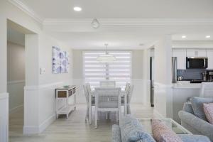 a dining room and kitchen with a table and chairs at Sundial A201- Gorgeous Beachfront Condo at Sundial in Sanibel +9 photos