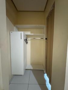 an empty kitchen with a white refrigerator in a room at Comodoro Hotel e Churrascaria in Floriano +45 photos