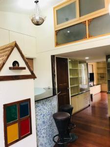a kitchen with colorful cabinets and stools in a room at Miaoli Sanyi Travelling Homestay in Sanyi