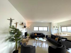 a living room with a couch and a cross on the wall at 2 Bedroom Apartment AYA tower Mar Mikhael - Beirut in Beirut +44 photos
