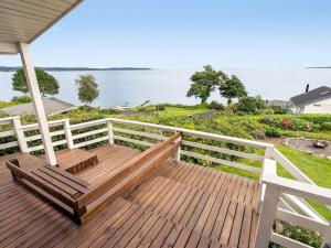 a wooden deck with two benches on top of the water at Holiday Home Gesine - 50m to the inlet by Interhome in Børkop