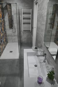 a bathroom with a white sink and a shower at Affittacamere ONE in Frascineto
