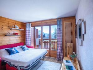 a bedroom with a bed and a large window at Apartment Villars Vacances 20 by Interhome in Villars-sur-Ollon +23 photos