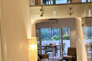 a living room with a table and chairs in a house at Stunning beach apartment in Almancil