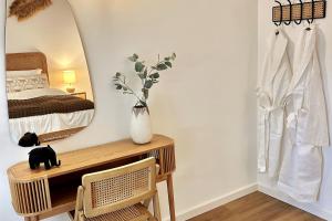a bedroom with a mirror and a desk and a bed at Stunning beach apartment in Almancil