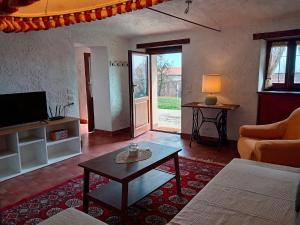 a living room with a couch and a coffee table at La Gemma Netro in Netro