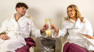 a man and a woman holding glasses of wine at Midlands Park Hotel in Portlaoise