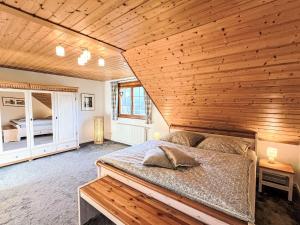 a bedroom with a bed and a wooden ceiling at Apartment Kleine Auszeit by Interhome in Menzenschwand