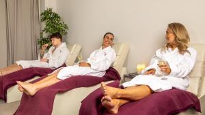 three people in white robes sitting in chairs at Midlands Park Hotel in Portlaoise